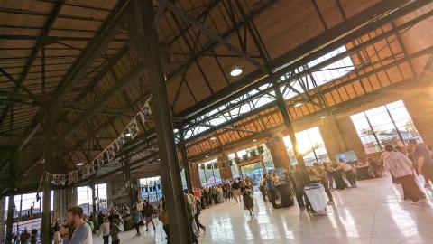 An image of a large old brick factory complex with a new stage and bullriding installed in the middle in Atlanta.