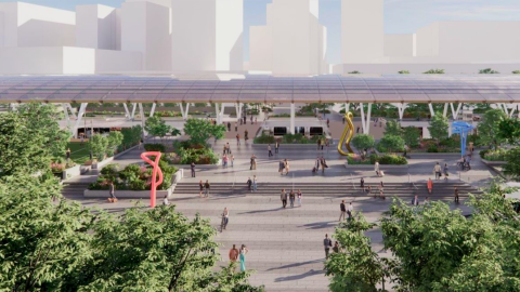 A rendering showing a large downtown Atlanta train station with a new canopy and open plazas with many trees. 