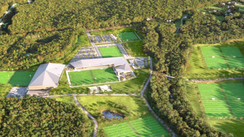 An aerial photo of a large soccer complex surrounded by trees with many buildings south of downtown Atlanta. 