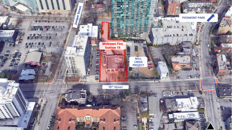 An image of a fire station site in Midtown Atlanta surrounded by large glassy buildings and cranes. 