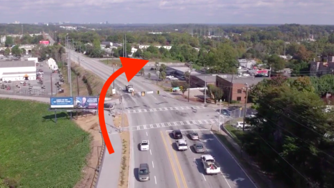 An overview of a street and trail where the Atlanta Beltline is built today and will be extended toward many trees and bulidings.