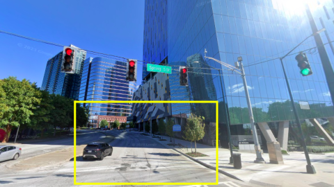 An image showing a wide street in Atlanta with towering new glassy buildings all around it. 