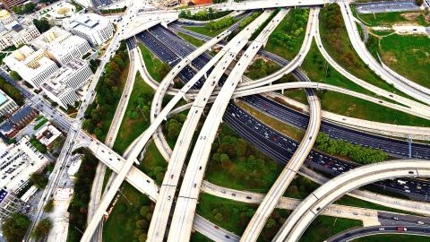 A photo of many highways over an interstate next to downtown Atlanta and its high-rises. 