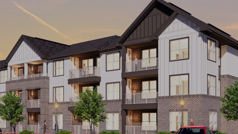 An image of a site location where a low-rise new apartment building is being built under hazy blue skies outside Atlanta.