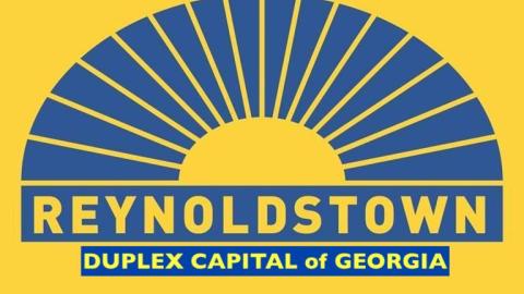 A blue and yellow sign for the neighborhood Reynoldstown in Atlanta with funny words on it. 