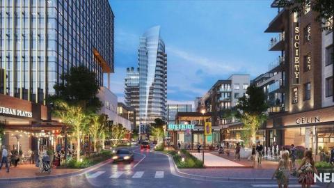 A rendering of a giant new development with many new buildings under a dark blue sky.