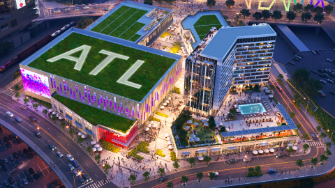 A rendering of a huge new development district in Atlanta beside many old buildings and two large stadiums. 