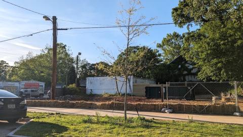 A street corner in Atlanta with dirt where a small corner building was recently bulldozed.