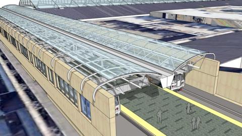 A new MARTA station shown with a glass canopy overhead with a giant airport next door in Atlanta.