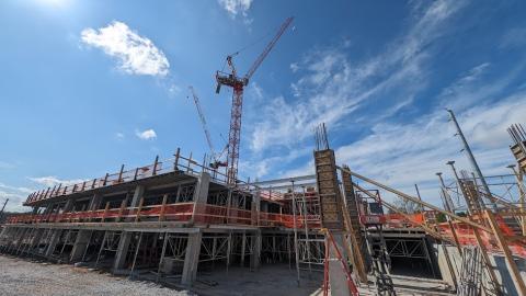 A photo of a new development under construction with concrete under blue skies.