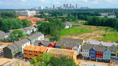 An aerial pic of a huge new home development with many colorful houses south of downtown Atlanta.