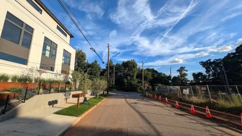 A photo of a large open lot next to many new modern houses under blue skies in Atlanta. 