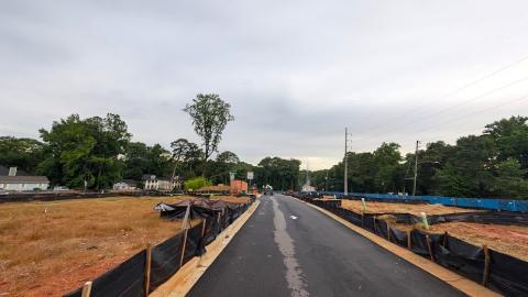 A photo of a large construction site with new streets and much mud under gray skies in Atlanta.