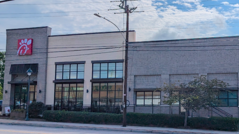 A photo of a row of buildings that look like an old main street with a Chick-fil-A attached.