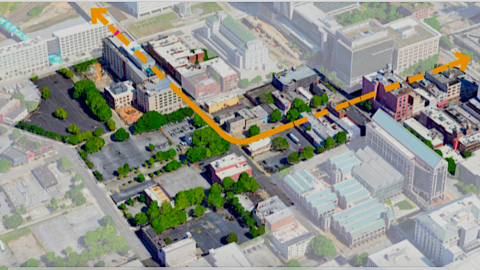 A rending of a large section of downtown Atlanta with many revitalized buildings and wide streets near a big railroad.