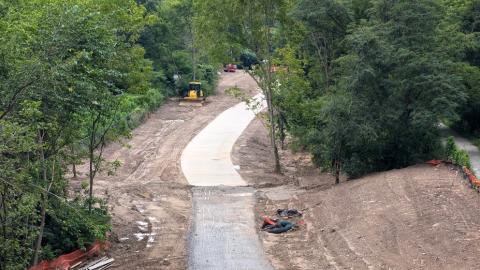 A photo of a new trail being laid between trees and much dirt under gray skies in Atlanta.