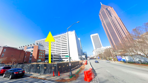 An empty corner site in downtown Atlanta near two wide streets where a hotel development is planned.