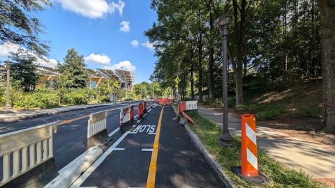 An image of a large new bicycle lane being built through a college campus in the middle of Atlanta near a huge interstate.