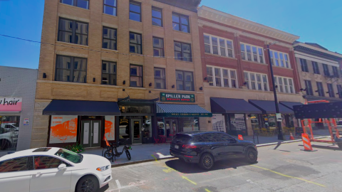 A photo of a long row of restored historic buildings under blue skies near a wide Atlanta street.