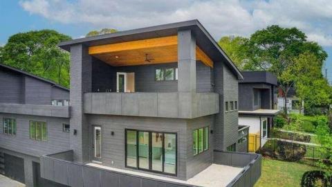 A photo showing a large new black and wood duplex in the Reynoldstown neighborhood of Atlanta.