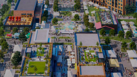 An image of a large new town center with many buildings and plazas and people outdoors, north of Atlanta. 