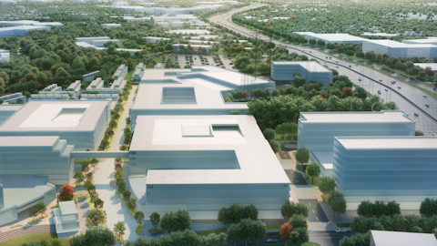 An image showing a huge development site in Atlanta near a wide interstate and many low-rise buildings and trees.