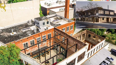 A photo of a complex of very old buildings near downtown Atlanta with a parking lot and wide street nearby under blue skies.