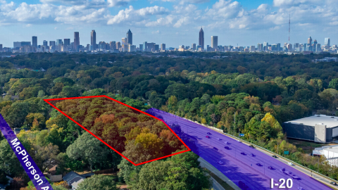 An overview of a large development site on the eastside of Atlanta with a large city in the distance.