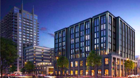 An image of a large hotel site under blue skies near a wide street in Atlanta.