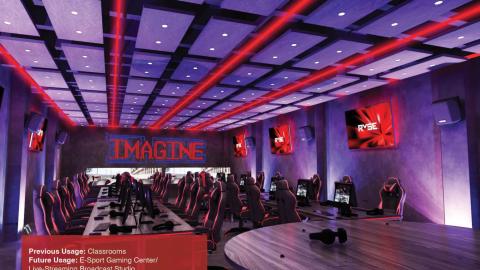 A rendering of a new esports gaming center with red and purple lighting and many screens and modern chairs.