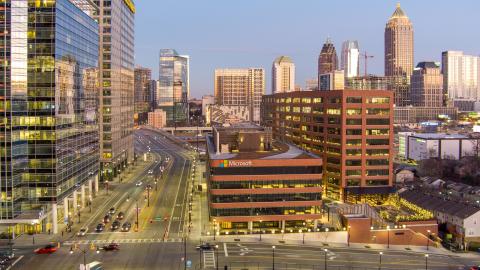 A photo of a large retail and dining district near Midtown Atlanta with many tall glassy and concrete buildings.