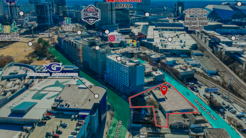 An overview of a large site in downtown Atlanta where a high-rise project with various uses is being proposed, next to a large blue aquarium.