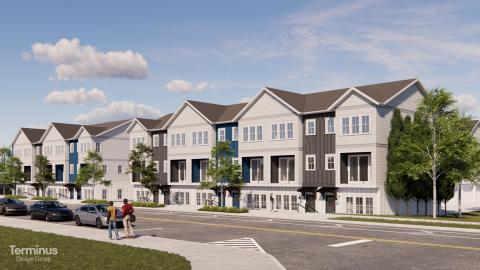 An image of a large new townhome project site along a wide Atlanta street near a huge green cemetery.