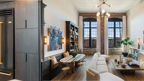 A large white condo with huge windows and a black fridge in Atlanta.