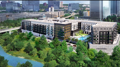 A rendering of a large white brown and black apartment complex next to a wide interstate and lake in north Atlanta.