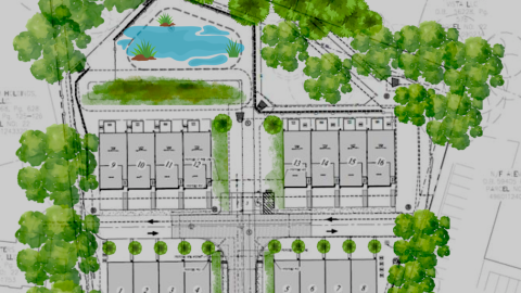 An image showing a large infill site near many trees and a wide street for new townhomes.