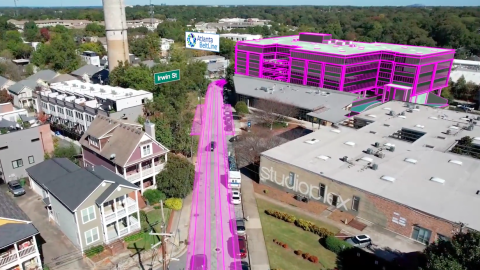 An overview of a city with pink lines where a streetcar is planned near many buildings.