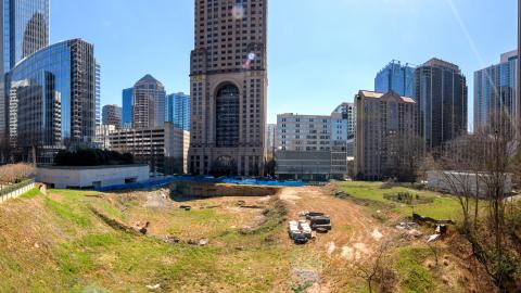 An overview photo of a large empty site in the middle of Midtown Atlanta where a new park is planned among many new buildings. 