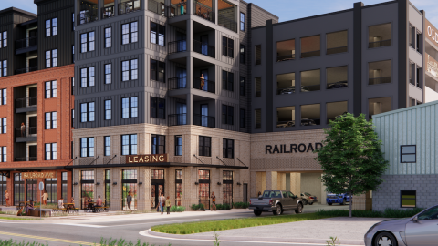 An image of a large development near wide roads with shops at the bottom under blue skies north of downtown Atlanta.