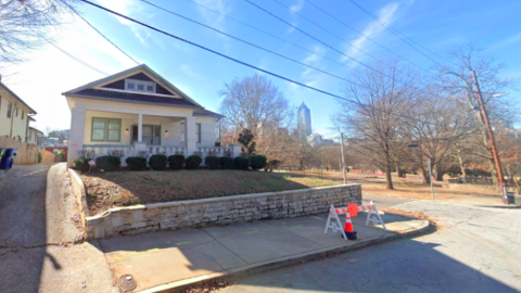 An image of a corner site where a bland and wood-clad six-story apartment building is planned near downtown Atlanta. 