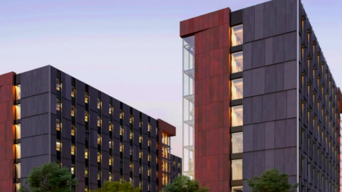 Two black and brown towers for Georgia Tech students shown under blue gray skies in Atlanta.