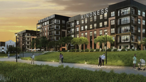 A large development of an apartment complex under orange and brown skies near a wide trail in Atlanta. 