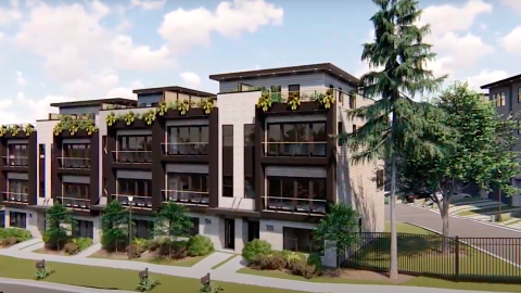 A rendering of a large townhome project under blue skies near wide streets in Atlanta.