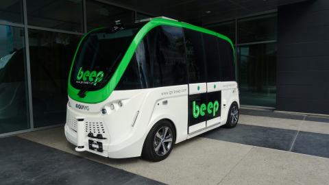 A white and green mini bus without a driver seen in Florida. 