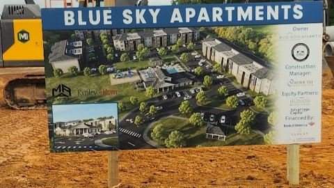 An image of a large construction site where affordable housing is being built near the Atlanta airport with much red dirt under blue skies.