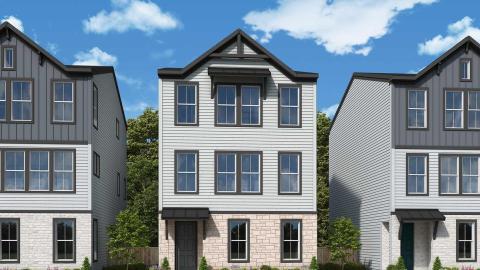 A row of modern-style tall standalone homes under blue skies with green grasses in front in Decatur near Atlanta.