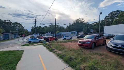 A photo of a wide lot under cloudy evening skies near many trees houses and streets on Atlanta's eastside.