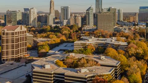 A large office campus showing among many trees and large buildings under blue skies in Atlanta.