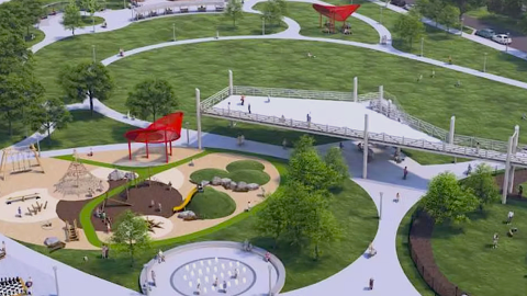 An image of a large site where a green park with a playground and splash pad and trees is being implemented in Atlanta, south of downtown.