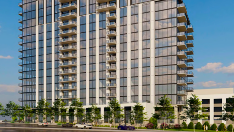 A tall glass and beige block condo tower under blue skies shown with renderings in Buckhead Atlanta.